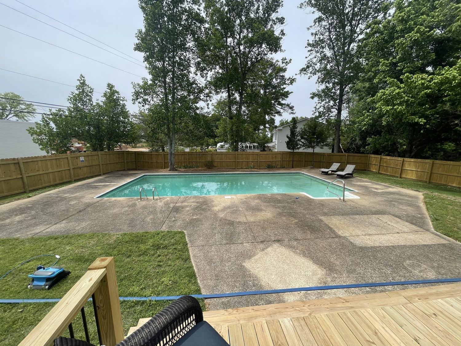 Pool deck concrete patchy and discoloured before cleaning